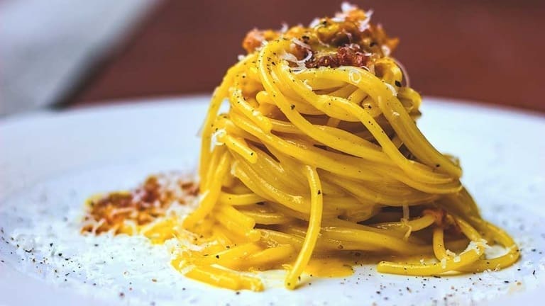Spaghetti carbonara recipe with guanciale, beaten eggs, pecorino cheese