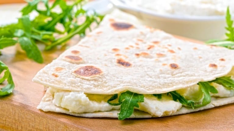 Piadina with Squacquerone cheese and arugola, Italian flat bread with cheese