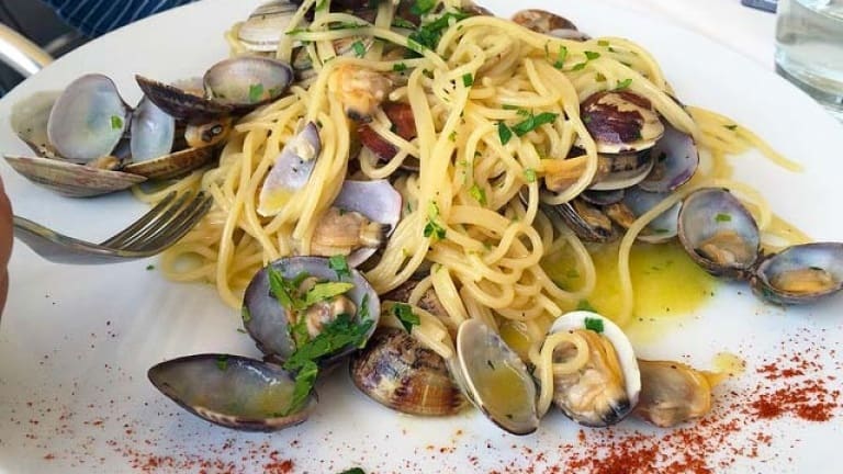 Spaghetti with clams and paprika, spicy seafood sauce for pasta, Italian Food