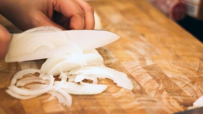 Chopping onion for making risotto alla Milanese, best Italian recipes