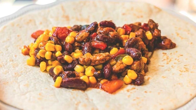 Mexican burritos original recipe with meat, red beans, corn, peppers