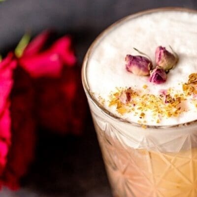 Zabaione sour autumn cocktail with rum, roses, eggnog and coconut