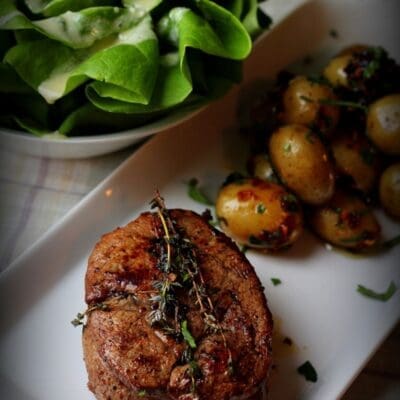 Grilled Beef filet mignon recipe with baby potatoes and onions and lettuce salad