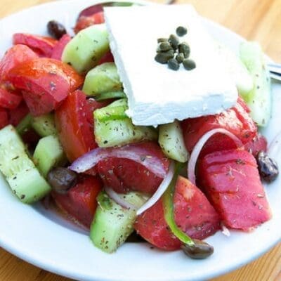 Greek salad original recipe with tomatoes, feta, onions, olives and cucumbers